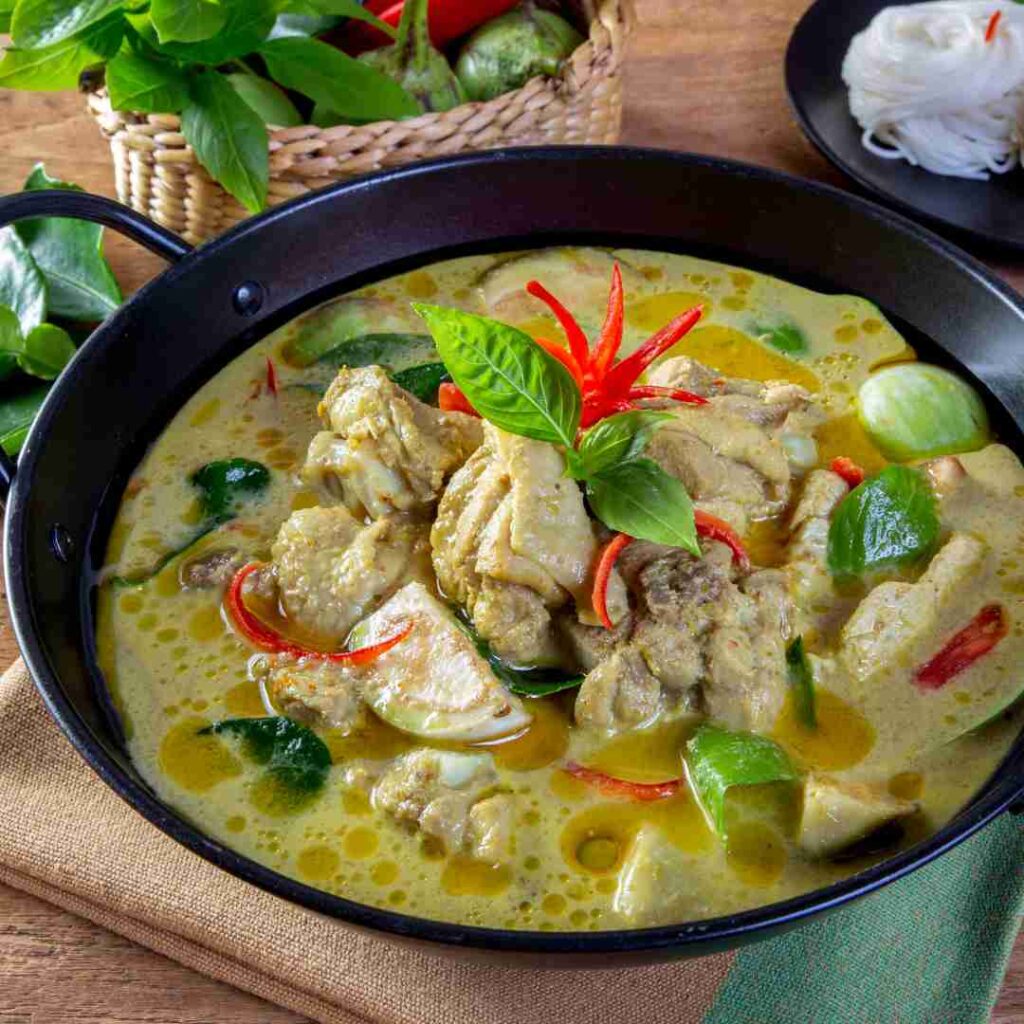 A vibrant bowl of Halal Thai Green Curry (Kaeng Khiao Wan) with chicken, a classic and creamy dish for any foodie visiting Bangkok.